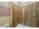 Modern bathroom with a glass shower door and tiled shower stall at 1432 Rolling Fairway Dr, Davenport, FL 33896