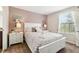 Comfortable bedroom with a plush bed, soft pillows, and warm, inviting decor at 1432 Rolling Fairway Dr, Davenport, FL 33896