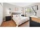 Well-lit bedroom with neutral walls, carpet floors, one window, and a large comfortable bed at 1432 Rolling Fairway Dr, Davenport, FL 33896
