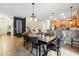 Well-lit dining area flows into the kitchen, featuring ample seating and stylish decor at 1432 Rolling Fairway Dr, Davenport, FL 33896