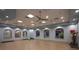 Light and airy exercise room with ample mirrors, fans, and windows for a refreshing workout experience at 1432 Rolling Fairway Dr, Davenport, FL 33896