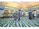 The fitness center is well-lit and spacious with modern exercise equipment and large windows at 1432 Rolling Fairway Dr, Davenport, FL 33896