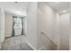 Light and airy upstairs hallway with soft carpet and natural light from nearby windows at 1432 Rolling Fairway Dr, Davenport, FL 33896