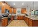 Spacious kitchen with granite countertops, stainless steel appliances and wooden cabinetry at 1432 Rolling Fairway Dr, Davenport, FL 33896