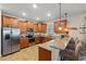 Modern kitchen with sleek stainless steel appliances, granite countertops, and bar seating at 1432 Rolling Fairway Dr, Davenport, FL 33896