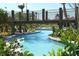 Tranquil view of a lazy river winding under a bridge, surrounded by lush landscaping at 1432 Rolling Fairway Dr, Davenport, FL 33896