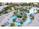 Aerial view of the winding pool and water features in a palm-lined community center at 1432 Rolling Fairway Dr, Davenport, FL 33896