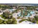 Aerial view of the community pool with lazy river, beach volleyball court and outdoor gathering spaces at 1432 Rolling Fairway Dr, Davenport, FL 33896