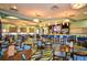 Community restaurant with tables, chairs, bar and pendant lighting offering a refined dining experience for residents at 1432 Rolling Fairway Dr, Davenport, FL 33896