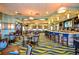 Restaurant featuring tables and chairs, a bar, a patterned carpet, and decorative hanging lights at 1432 Rolling Fairway Dr, Davenport, FL 33896