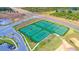 Aerial view of eight well-maintained tennis courts, a wonderful amenity within the community at 1432 Rolling Fairway Dr, Davenport, FL 33896