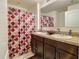 Bathroom featuring double sinks with granite countertops and shower with patterned curtain at 1459 Rylee Rock Way, Kissimmee, FL 34744