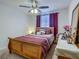 Bright bedroom with ceiling fan, natural light, and complementary furnishings at 1459 Rylee Rock Way, Kissimmee, FL 34744