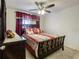 Cozy bedroom with neutral carpet, a ceiling fan, and decorative curtains at 1459 Rylee Rock Way, Kissimmee, FL 34744