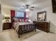 Serene bedroom with neutral walls, plush carpet, and dark wood furniture at 1459 Rylee Rock Way, Kissimmee, FL 34744