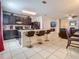 Modern kitchen with dark cabinetry, granite counters, island seating, and open layout at 1459 Rylee Rock Way, Kissimmee, FL 34744