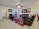 Comfortable living room with ceiling fan, tile flooring, and stylish decor at 1459 Rylee Rock Way, Kissimmee, FL 34744