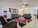 Well-lit living room with tile flooring, ceiling fan, and comfortable seating at 1459 Rylee Rock Way, Kissimmee, FL 34744