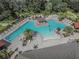 Aerial view of a luxurious community pool with multiple lounge areas and ample seating at 1459 Rylee Rock Way, Kissimmee, FL 34744