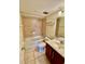 Bathroom features include vanity, toilet and shower-tub combo with tiled surround at 1916 Conway Rd # 11, Orlando, FL 32812