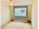 Bedroom with neutral walls, ceiling fan, and large window providing natural light at 1916 Conway Rd # 11, Orlando, FL 32812