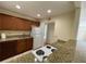 Galley kitchen with granite countertops, wood cabinets, and white appliances at 1916 Conway Rd # 11, Orlando, FL 32812