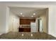 Open kitchen featuring granite countertops, white refrigerator, and wood cabinetry at 1916 Conway Rd # 11, Orlando, FL 32812