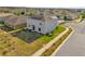 Aerial view of backyard and home, featuring solar panels and green space at 204 Taft Dr, Davenport, FL 33837