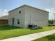 Side view of the property showcasing green grass and AC units at 204 Taft Dr, Davenport, FL 33837