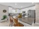 Bright kitchen with white cabinetry, stainless appliances, and a spacious island topped with stylish decor at 204 Taft Dr, Davenport, FL 33837