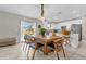 Open floor plan showcasing a kitchen with white cabinets and stainless steel appliances, adjacent to a dining area at 204 Taft Dr, Davenport, FL 33837