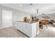 Kitchen island with white cabinets, contrasting countertops, and decor that opens into the dining and living area at 204 Taft Dr, Davenport, FL 33837