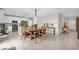Open floor plan showcasing a kitchen with white cabinets and stainless steel appliances, adjacent to a dining area at 204 Taft Dr, Davenport, FL 33837