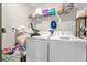 Bright laundry room featuring white appliances and a wire rack for organized storage at 204 Taft Dr, Davenport, FL 33837