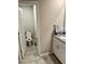 Bright half-bath features tile flooring, granite counters, and white cabinetry at 2040 Milkweed St, Ocoee, FL 34761