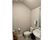 Cozy half-bathroom featuring a pedestal sink, neutral walls, and tiled floors at 2040 Milkweed St, Ocoee, FL 34761