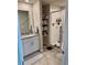 Modern bathroom featuring a glass shower door and convenient built-in shelving for storage at 2040 Milkweed St, Ocoee, FL 34761