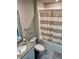 Bathroom showcasing a shower-tub combo with a patterned curtain and granite countertop vanity at 2040 Milkweed St, Ocoee, FL 34761