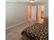 Bedroom with doorway to bathroom, neutral walls, and carpeted floors at 2040 Milkweed St, Ocoee, FL 34761