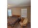 Bedroom featuring two windows, neutral walls, and carpeted floors at 2040 Milkweed St, Ocoee, FL 34761