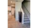 Open-concept living area with tile flooring, staircase, and access to the kitchen featuring stainless steel appliances at 2040 Milkweed St, Ocoee, FL 34761