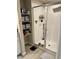 Modern bathroom featuring a glass shower door and convenient built-in shelving for storage at 2040 Milkweed St, Ocoee, FL 34761