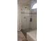 Bathroom shower with glass door and marble look tile at 205 Lexingdale Dr, Orlando, FL 32828