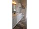 Bright bathroom featuring a double sink vanity with granite countertop and wood-look tile flooring at 205 Lexingdale Dr, Orlando, FL 32828