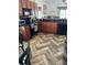 Cozy kitchen features wood cabinets, black countertops, modern appliances, and stylish herringbone flooring at 205 Lexingdale Dr, Orlando, FL 32828