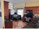 Full kitchen view with eat-in table, wood cabinets, black countertops, and stainless steel appliances at 205 Lexingdale Dr, Orlando, FL 32828