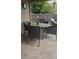 Outdoor dining area with wicker chairs and round table with a small orchid in the center at 205 Lexingdale Dr, Orlando, FL 32828