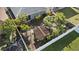 Aerial view of the landscaped backyard with a gazebo surrounded by lush greenery and a white fence at 2102 Congress Ln, St Cloud, FL 34769