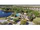 Aerial view of the community clubhouse, pool, and adjacent lake at 2102 Congress Ln, St Cloud, FL 34769