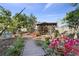 Lush backyard featuring a charming gazebo, wooden walkways, and beautiful flowering plants at 2102 Congress Ln, St Cloud, FL 34769